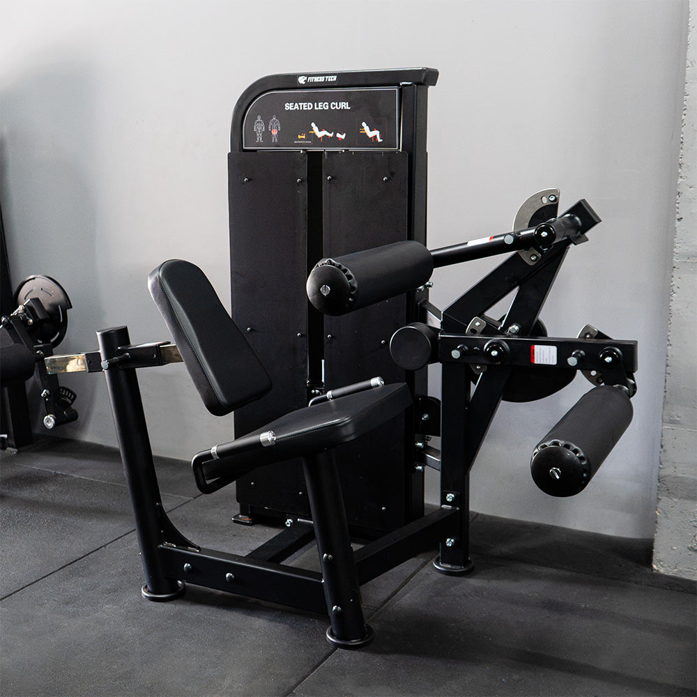 Femoral sentado | Máquina selectorizada - Compact Series lateral